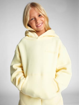 Minimalist Kids Hoodie: Arina is 9 wearing a size S