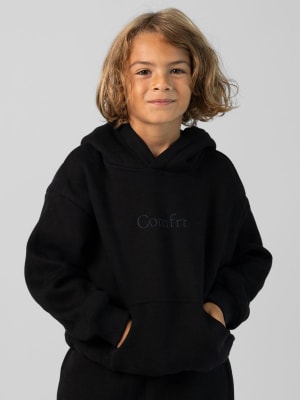 Signature Kids Hoodie: Jaydn is 7 wearing a size S