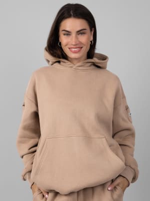 Travel Essentials Hoodie™: Lauren is 5’8” and wears a size M