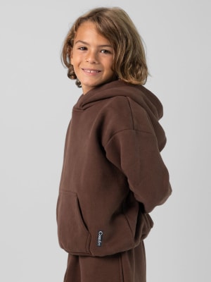 The Standard Kids Hoodie: Jaydn is 7 wearing a size S