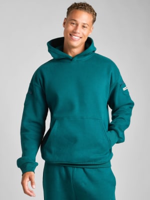 Travel Essentials Hoodie: Evan is 6′4″ wearing a size M