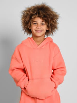 Signature Kids Hoodie: Logan is 8 wearing a size S