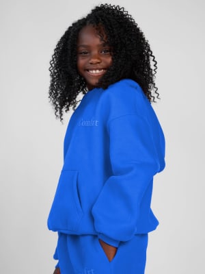Minimalist Kids Hoodie: Hattie is 7 wearing a size S