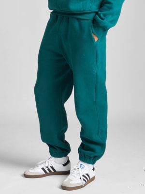 Travel Essentials Sweatpants: Evan is 6′4″ wearing a size M