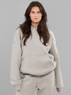 Travel Essentials Hoodie: Lauren is 5β²8β³ wearing a size M