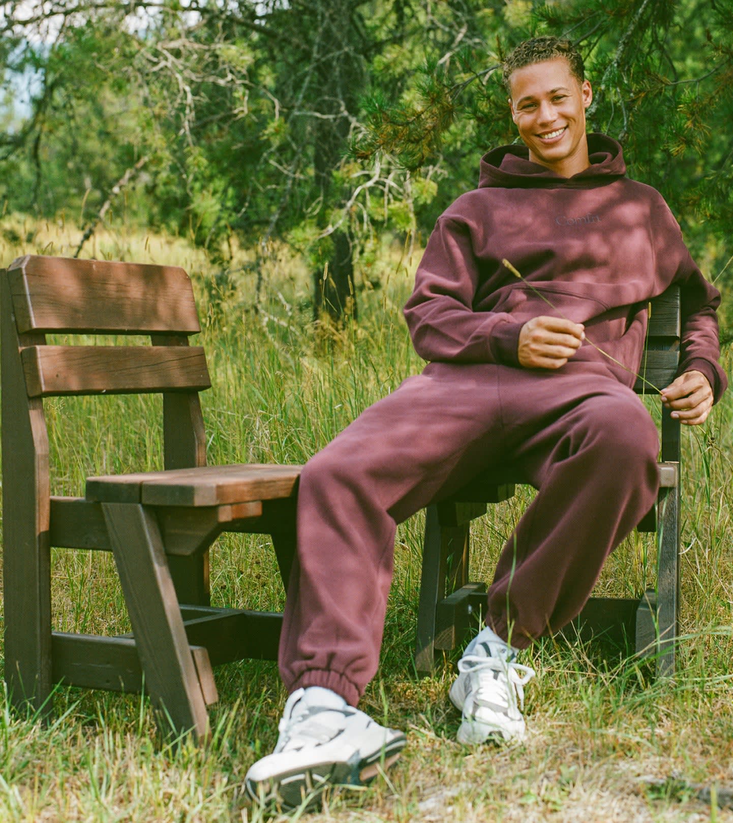 Person smiling while seated outdoors